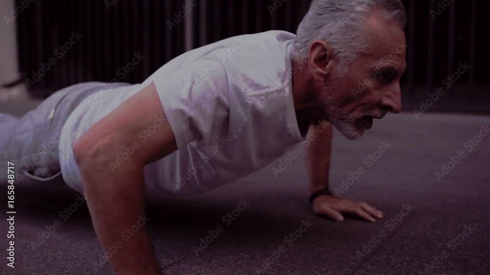 Strong senior man doing press up exercises