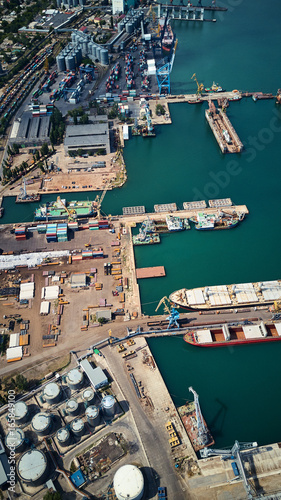 aerial view of sea port with ships and wheat silos storage