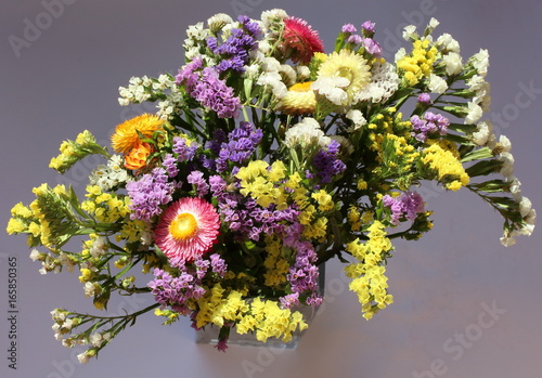 A bouquet of brightly colored flowers Helipterum and Limonium sinuatum.