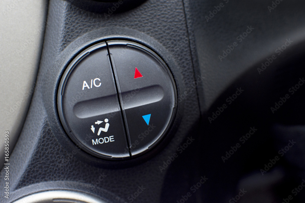 Controller button of air conditioner in car interior for temperature climate adjustment. selective focus. Automotive part concept. Controller button of air conditioner in car interior for temperature climate adjustment. selective focus. Automotive part concept.