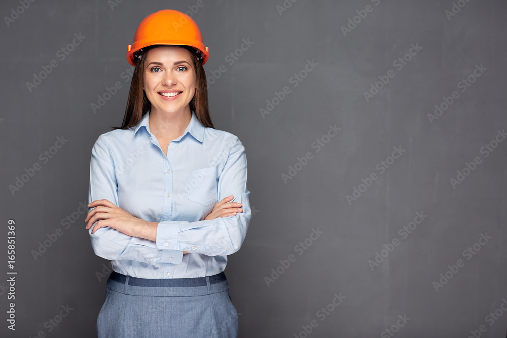 Smiling woman builder wearing safety helmet. Smiling woman builder wearing safety helmet.