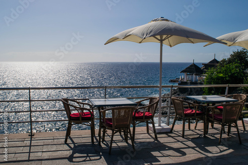 Table and chairs with umbrella and a beautiful sea view  Tenerife  Costa Adeje  canary islands  Spain