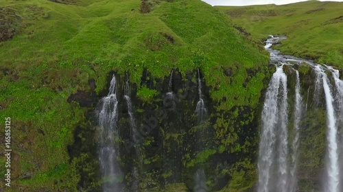 The river falls from the slope of the mountain by a waterfall. Andreev. photo