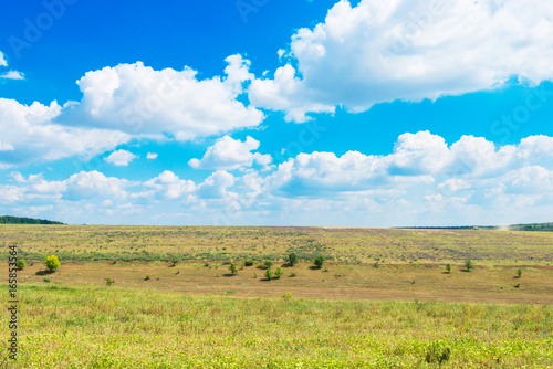  countryside with fields on the background of blue sky