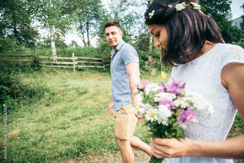 Romantic newlywed couple walking by country side Romantic newlywed couple walking by country side