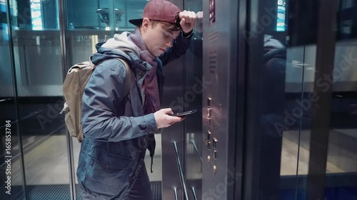 Sad man experienced stress and descends in the elevator in the subway photo