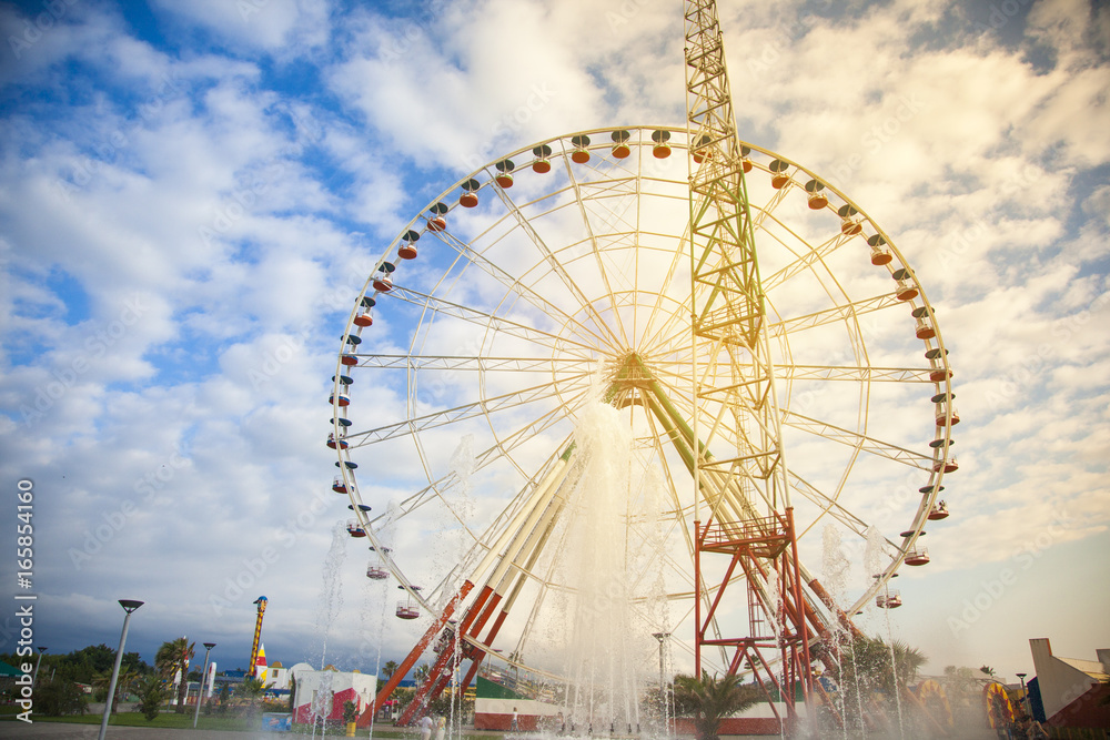 Ferris wheel with blue sky on background
