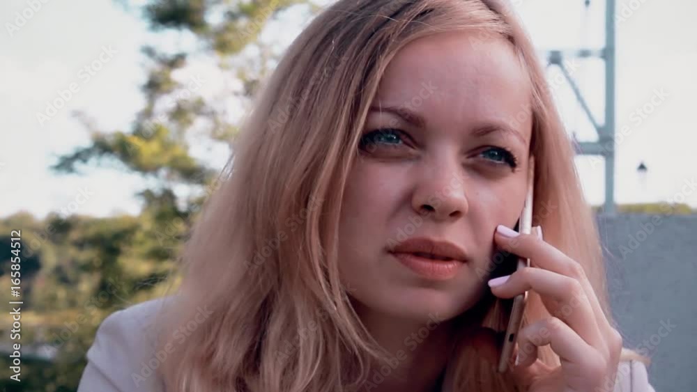 Joyful girl talking on the phone. Slow motion Joyful girl talking on the phone. Slow motion