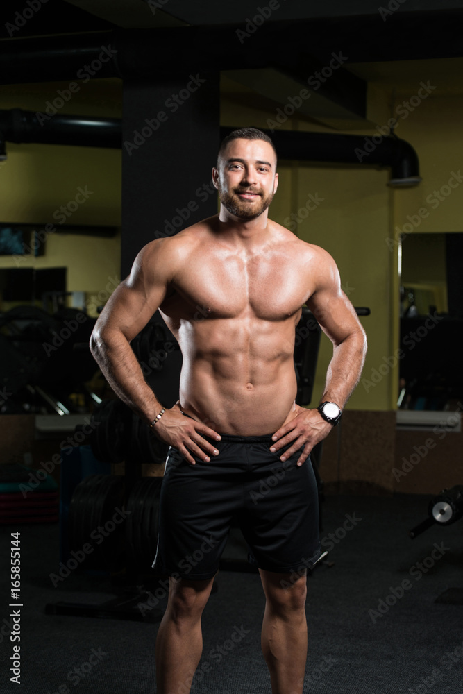 Serious Bodybuilder Standing In The Gym Serious Bodybuilder Standing In The Gym