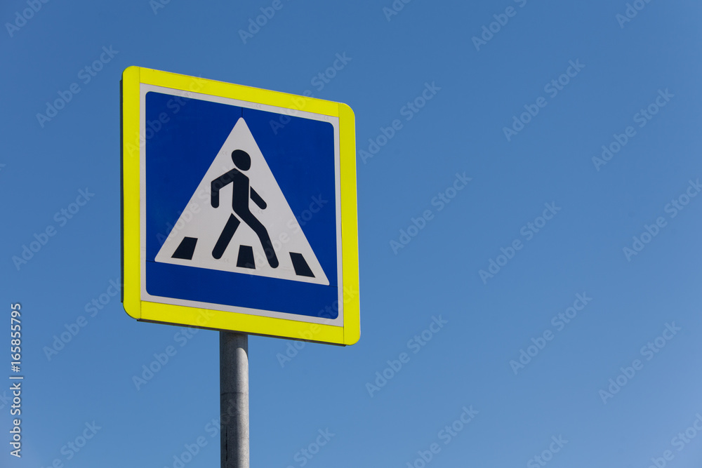 pedestrian crossing sign on a clear day against the sky pedestrian crossing sign on a clear day against the sky