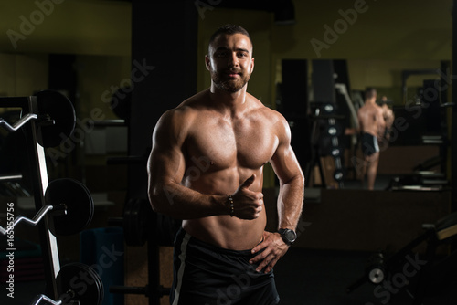 Fitness Man Flexing Muscles Showing Thumbs Up
