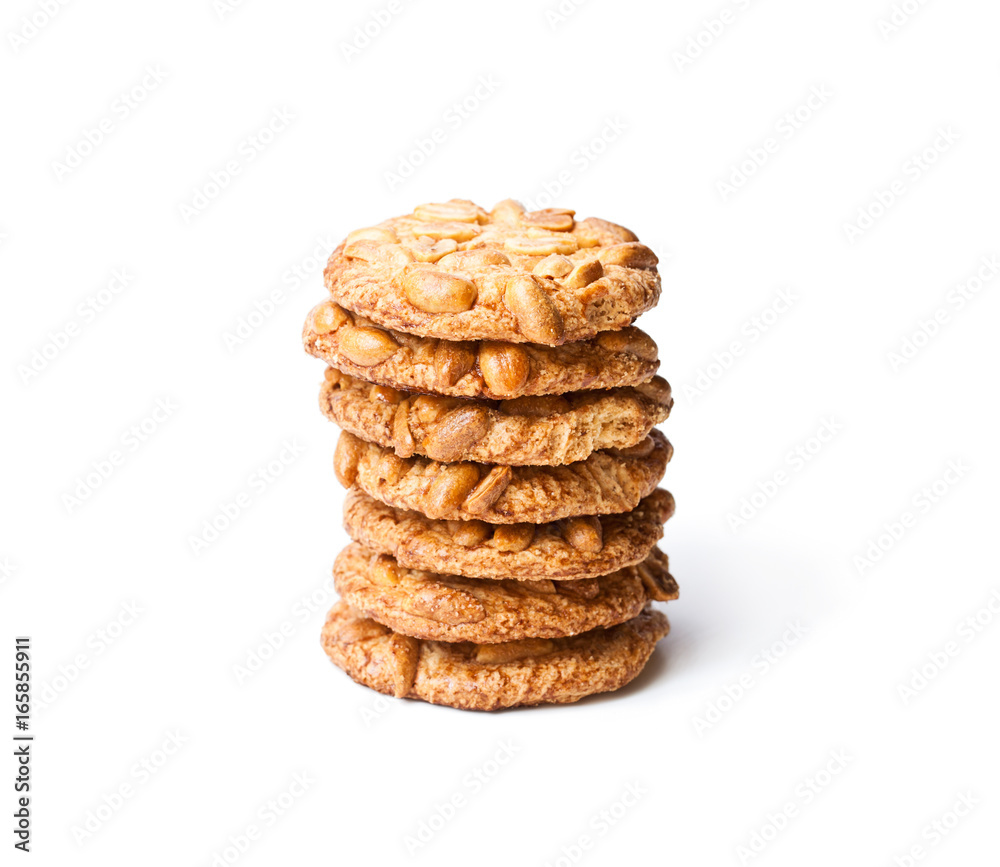 Stack of sugar cookies with monkey nuts isolated on white Stack of sugar cookies with monkey nuts isolated on white