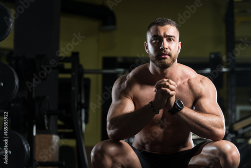 Muscular Man After Exercise Resting In Gym