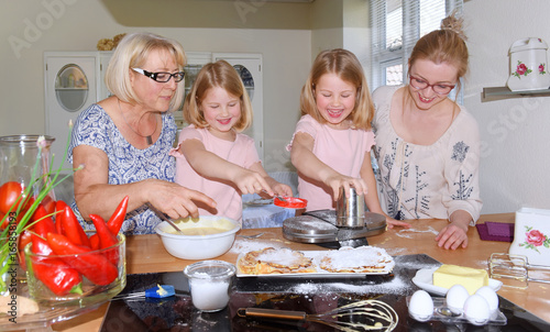 Mother and grandmother plan a family baking day for the two twins. The children get to know how to make waffles.