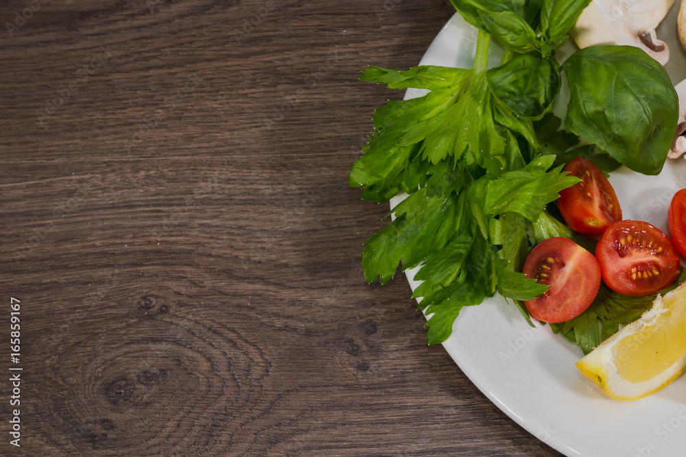 Parsley, lemon, pepper, champignons on a plate Parsley, lemon, pepper, champignons on a plate