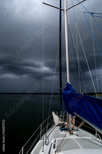 Sailing concept with boat and lake water storm weather