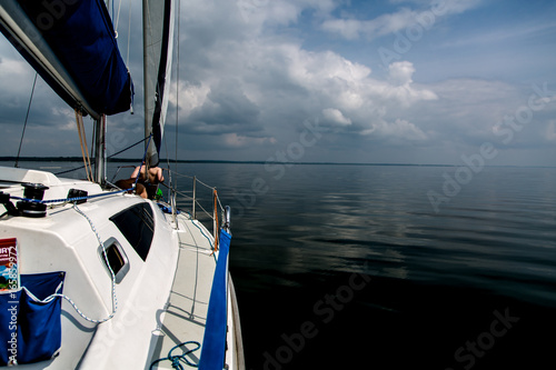 Sailing on white sail boat in Polish lake district