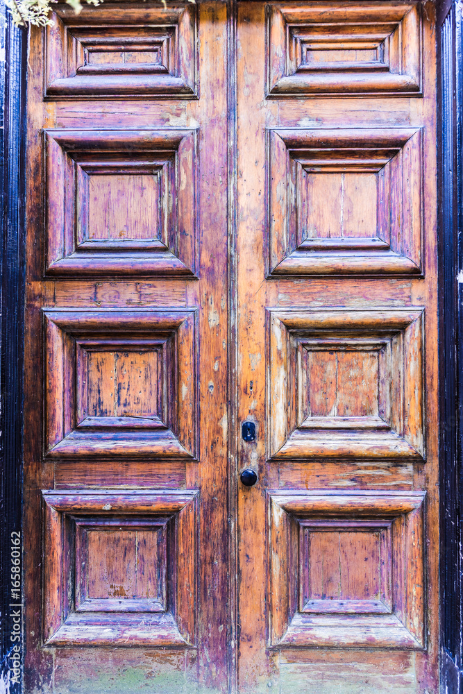 Closeup of old, worn antique wooden door with peeling paint Closeup of old, worn antique wooden door with peeling paint