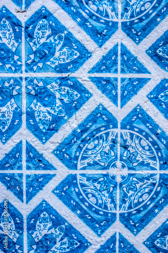 Tiles with typical geometric blue and white shapes of the houses in Portugal