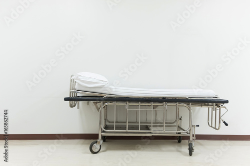 Empty stretcher trolley or hospital trolley for patient with white room.