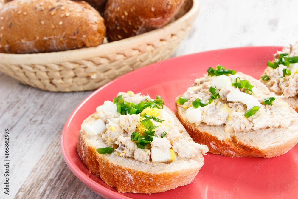 Mackerel or tuna fish paste sandwiches and fresh rolls in background Mackerel or tuna fish paste sandwiches and fresh rolls in background
