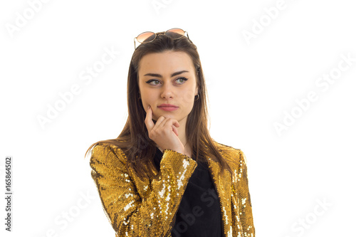 portrait of stylish young woman in golden jacket