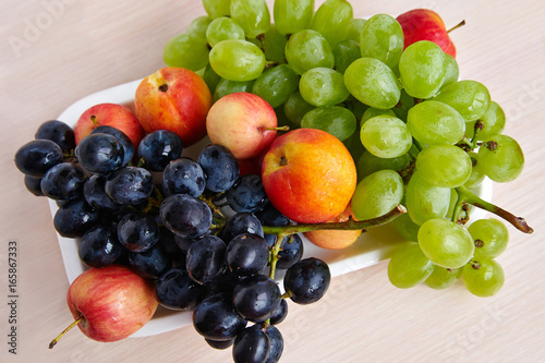 Ripe  fresh fruit on a white plate