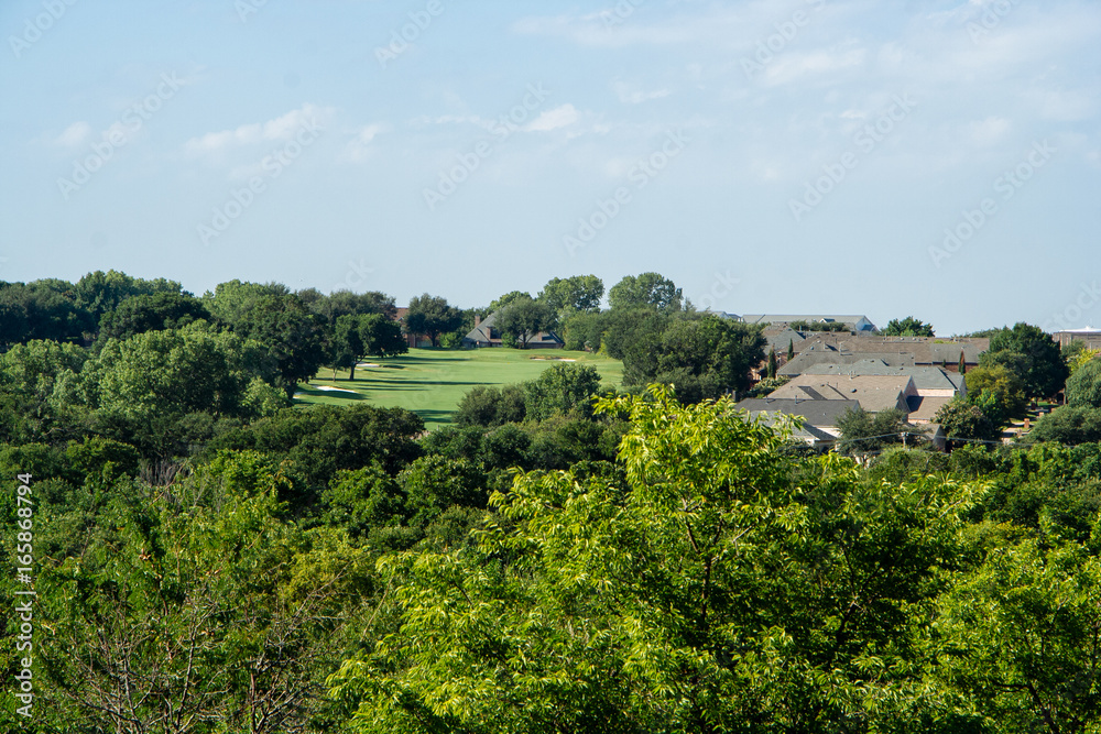 View of the golf club from the park on a summer morning