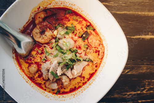 Tom Yum Goong (or Spicy prawn soup) mixed with meat ball noodles, Thai style and iconic popular taste of Thai foods.