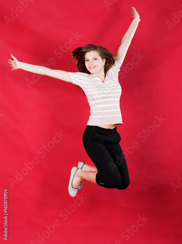 girl jumping of joy over red photo