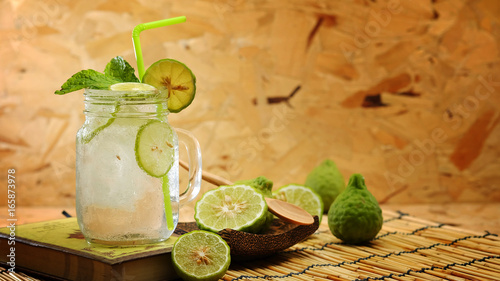 Kaffir lime So, Bergamot soda Cool drink, Thailand tradition Herb for Treatment of Acid Reflux, with Oriental Earth tone map background.Have some space for write wording