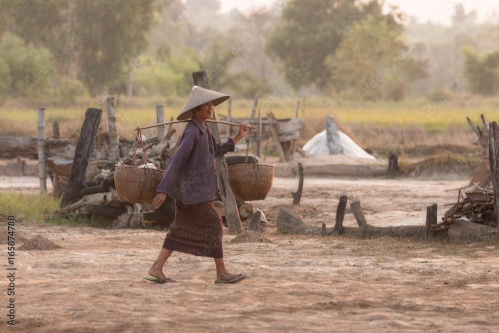 Farmer Ancient salt,Woman working on salt field in Thailand,Ancient salt  making,career in salt farming is reserved for Thai people. Stock Photo |  Adobe Stock