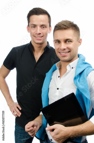 Two attractive students and a tablet. White background. 