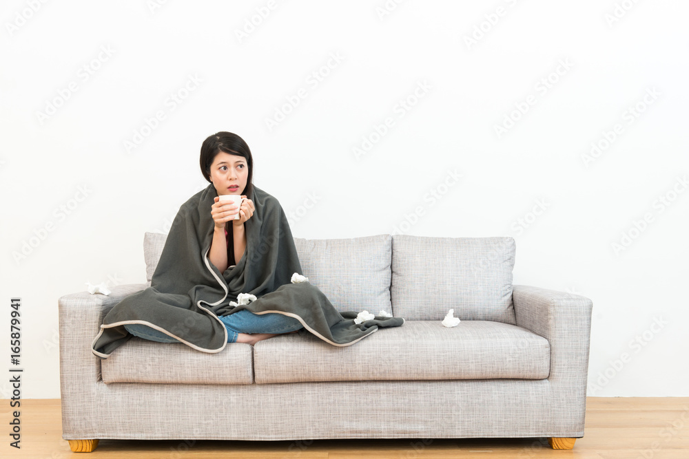 lady sitting on sofa couch and holding hot water lady sitting on sofa couch and holding hot water