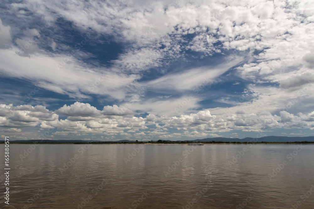 Calm river landscape with cloudy deep blue contrasting sky
