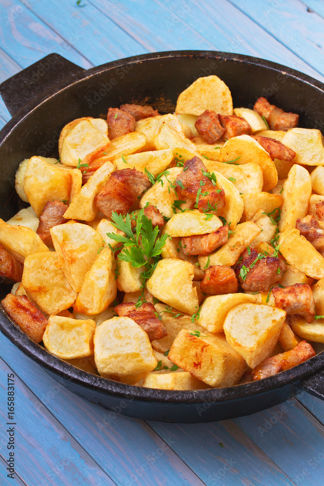 Pan-fried potato and meat. View from above, top studio shot