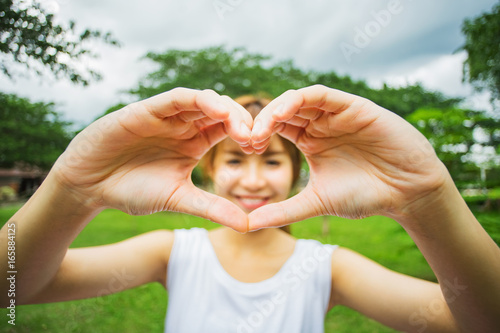 Woman show heart hands  selective focus. 