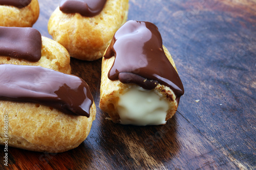 Traditional French dessert. Eclair with chocolate icing. Pastery concept photo