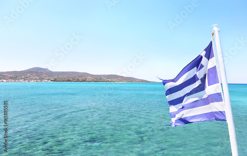Elafonisos island as seen from the ship and the greek flag waving - Lakonia Peloponnese Greece