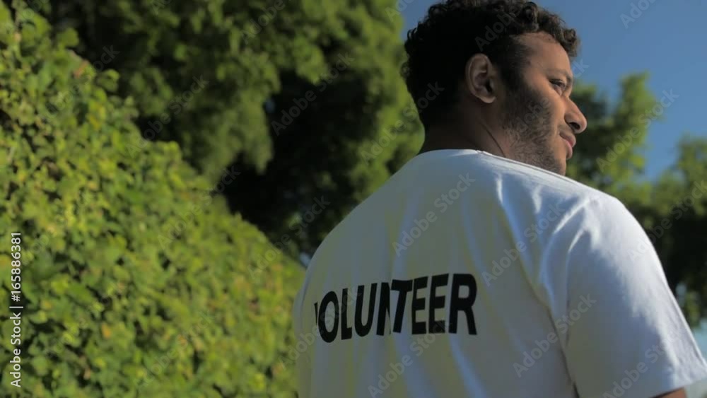 Rear view of a pleasant volunteer standing in the park Rear view of a pleasant volunteer standing in the park