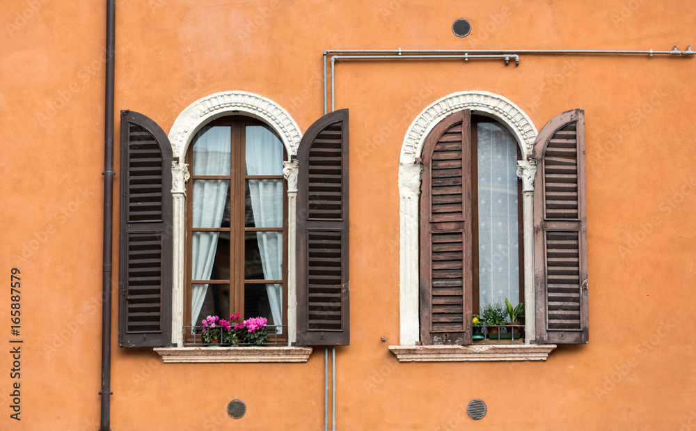 Old  windows with  wooden shutters and curtain in Italy