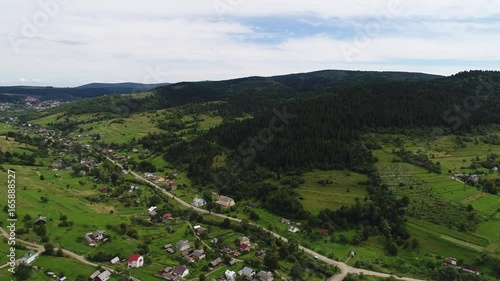 aerial view agriculture field and mountains. summer day. Summer day landscape.  Flying over the beautiful rural landscape. Aerial camera shot. 