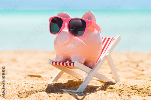 Pink Piggy Bank On The Deck Chair At Beach