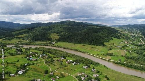 aerial view agriculture field and mountains. summer day. Summer day landscape.  Flying over the beautiful rural landscape. Aerial camera shot. 