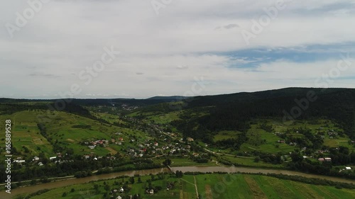 aerial view agriculture field and mountains. summer day. Summer day landscape.  Flying over the beautiful rural landscape. Aerial camera shot. 