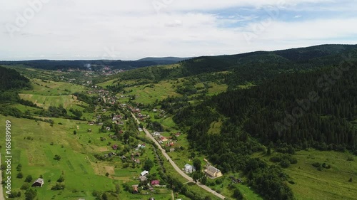 aerial view agriculture field and mountains. summer day. Summer day landscape.  Flying over the beautiful rural landscape. Aerial camera shot. 