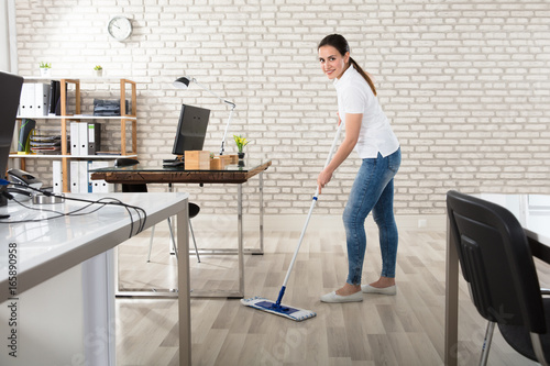 Young Woman Cleaning The Floor