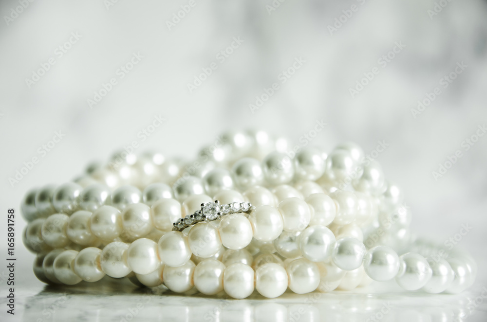 Silver ring with pearls on marble table Silver ring with pearls on marble table