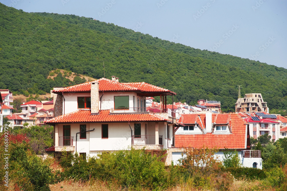 Panorama of the beautiful houses and red roofs of the Balkan mountains nature Bulgaria summer resort