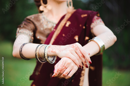 Mehndi tattoo. Woman Hands with black henna tattoos. India national traditions